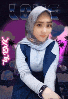 a woman in a hijab is standing in front of a love sign