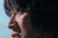 a close up of a man 's face with a scar on his face