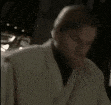 a close up of a person 's face in a dark room with a blurred background