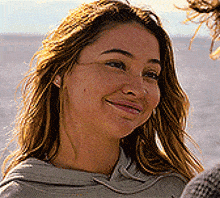 a close up of a woman 's face with a smile on it .