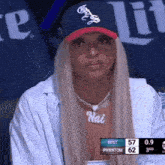 a woman wearing a hat and a necklace with the name hai on it