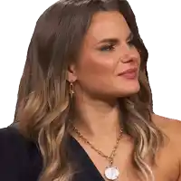 a woman wearing a necklace and earrings looks to the left