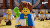 a lego character holding a cup and a green frog