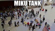 a large group of people are gathered in a circle with the caption miku tank