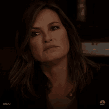 a close up of a woman 's face with a serious expression