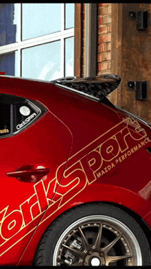 a red car with the word worksport on it
