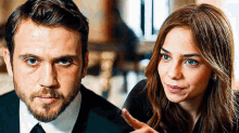 a man and a woman are looking at each other and the woman is pointing at the man