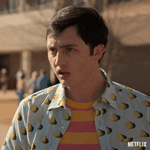 a man wearing a shirt with lemons on it and a netflix logo on the bottom