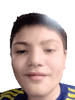 a close up of a boy 's face with a blue and yellow shirt on