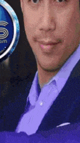 a close up of a man 's face in front of a sign that says s am