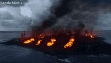 a picture of a burning island with sanda media written above it