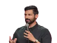 a man stands in front of a microphone with his hands outstretched