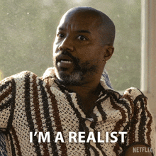 a man in a striped shirt says i 'm a realist on a netflix poster