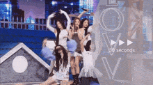 a group of girls are dancing on a stage with the words 30 seconds visible in the corner .