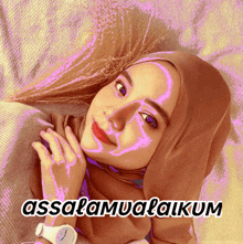 a picture of a woman wearing a hijab and a watch with the words assalamualaikum below her