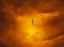 a silhouette of a person flying through a cloudy sky with kepler written on the bottom right