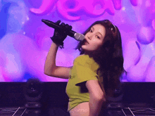 a woman is holding a microphone in front of a purple background that says jeon
