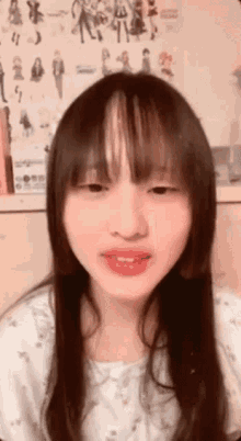 a close up of a woman 's face with long hair and bangs