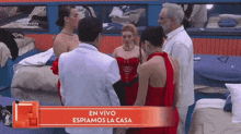 a group of people are standing around each other in a room .