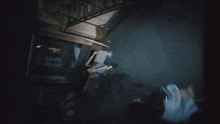 a woman peeking out from behind a door with a flashlight