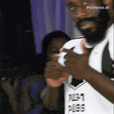 a man with a beard is wearing a white shirt that says just ples