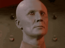 a bald man with the words " you are a robot " below him