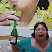 a woman is holding a bottle of wine and crying .