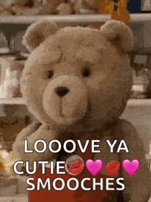 a teddy bear is holding a red heart and says looove ya cutie smooches .