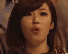 a close up of a woman making a funny face with her mouth wide open .