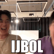 a man is laughing in front of a sign that says " ijbol " on it