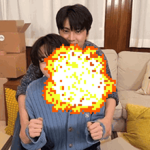 a man is hugging another man in front of a pixelated image of an explosion