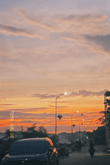 a car is parked on the side of the road in front of a sunset with a time stamp of 1:24
