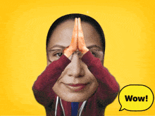 a woman with her hands on her face and a yellow speech bubble saying wow
