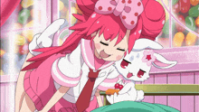 a girl with red hair is hugging a white rabbit with a bow on its head