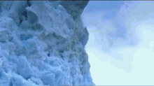 a large pile of snow against a cloudy sky