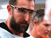 a man with a beard wearing a pair of goggles