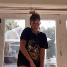 a woman wearing a t-shirt with a cartoon character on it