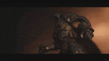 a man in armor is holding a sword