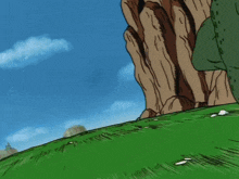 a cartoon character with a red scarf around his head is standing on a hill .