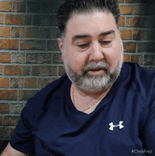 a man wearing a blue under armour shirt
