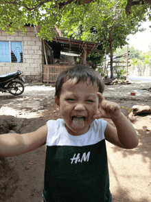a young boy wearing a shirt that says h & m