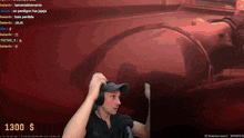 a man wearing headphones is playing a video game with a 1300 dollar donation