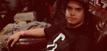 a man wearing a black shirt with a white number 3 on it
