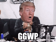 a man sitting in front of a microphone with a giant donald trump head on his head and the words ggwp below him
