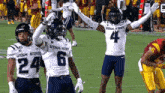 two utah state football players are celebrating a touchdown