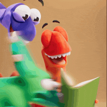 a cartoon character reading a book next to another cartoon character