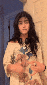 a girl wearing headphones and a t-shirt that says ' king ' on the front