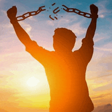 a silhouette of a man holding a chain in his hands .
