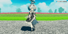 a girl in a black and white dress is standing in front of a field of flowers and trees