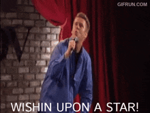 a man singing into a microphone with the words wishin upon a star written below him